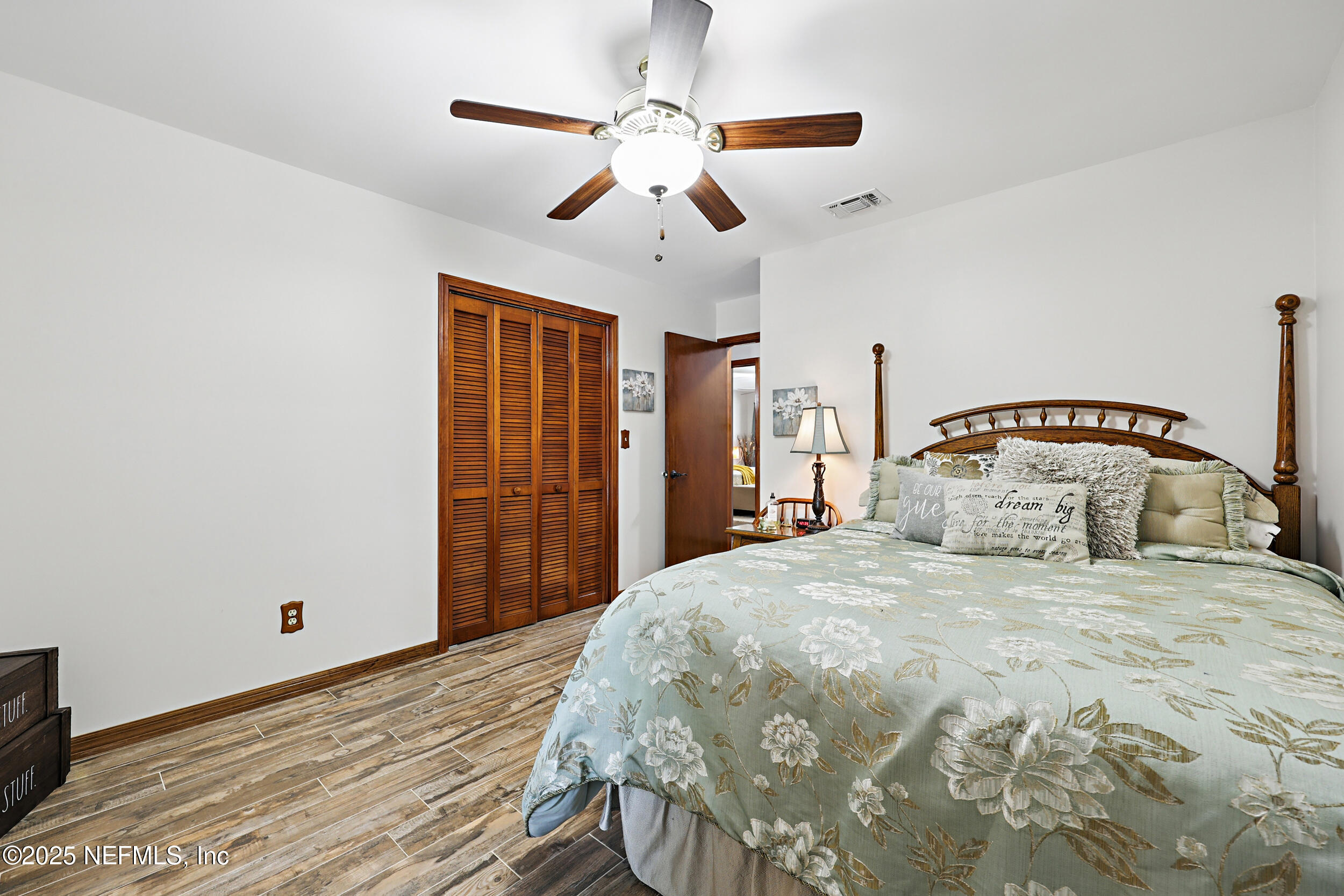 3154 Brooks Road Fleming Island, FL 32003 - Photo 27 of 53 a bedroom with a bed and a chandelier