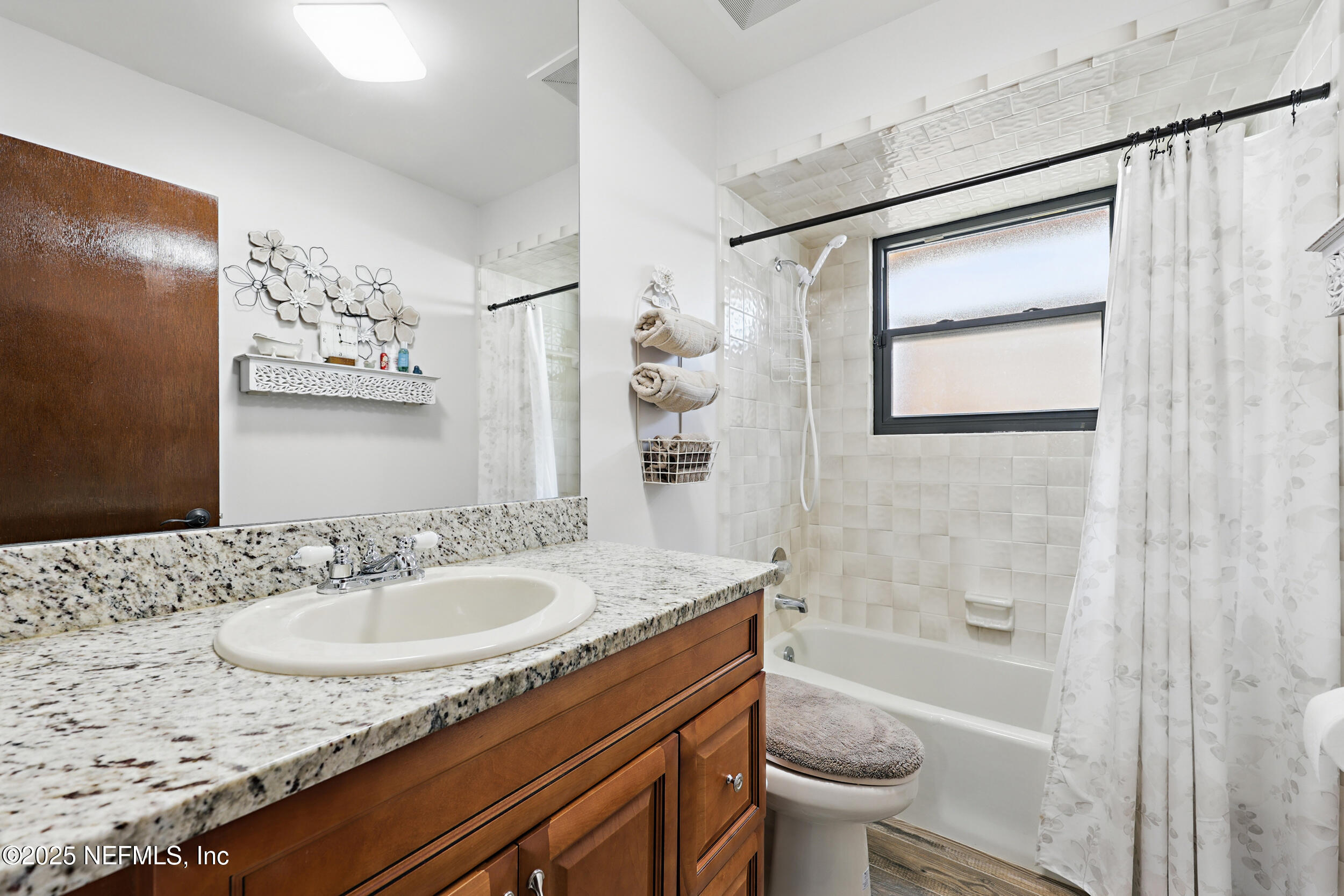 3154 Brooks Road Fleming Island, FL 32003 - Photo 28 of 53 a bathroom with a granite countertop sink a toilet and a bathtub