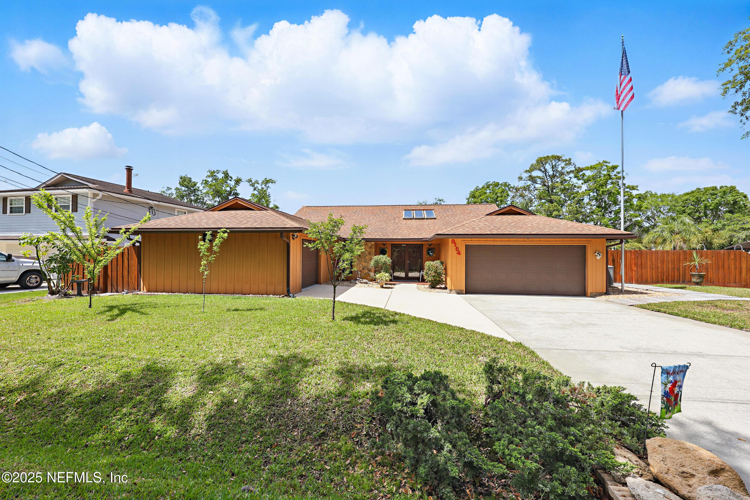 3154 Brooks Road Fleming Island, FL 32003 - Photo 42 of 53 a front view of a house with a garden and trees