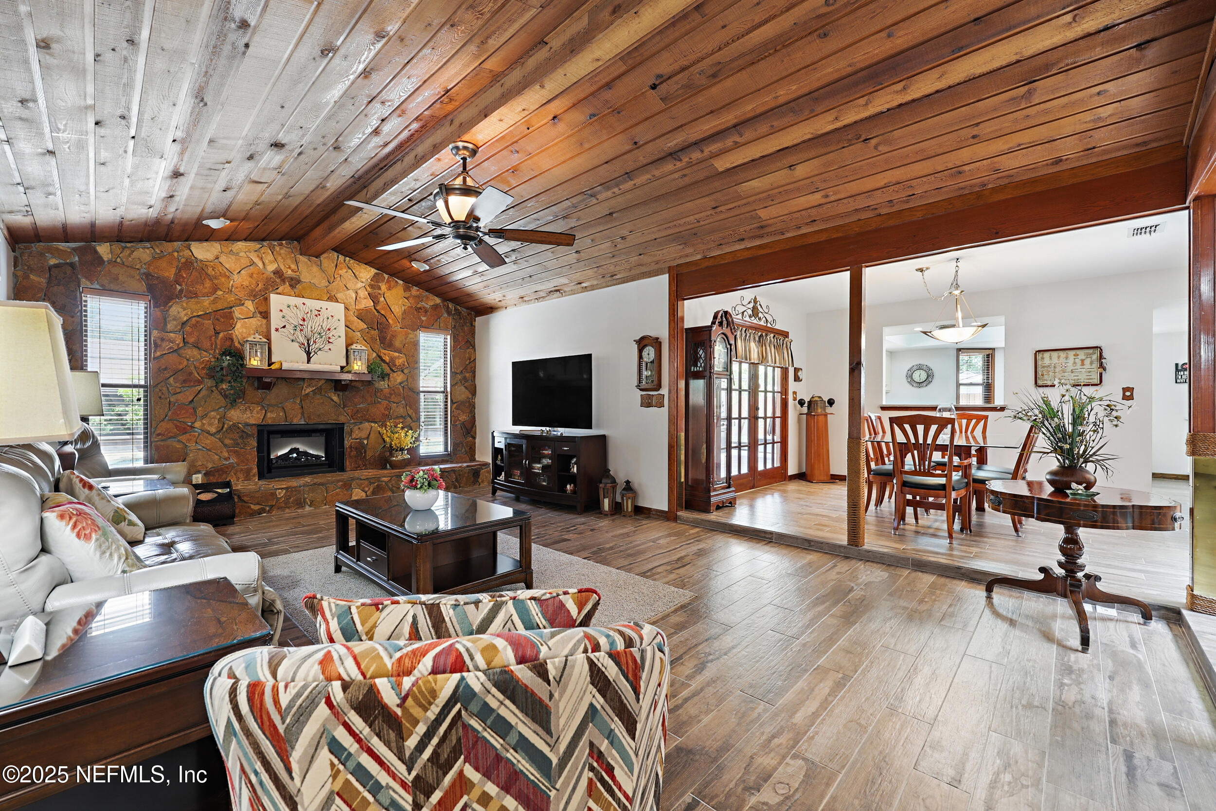 3154 Brooks Road Fleming Island, FL 32003 - Photo 10 of 53 a living room with furniture a fireplace and a flat screen tv