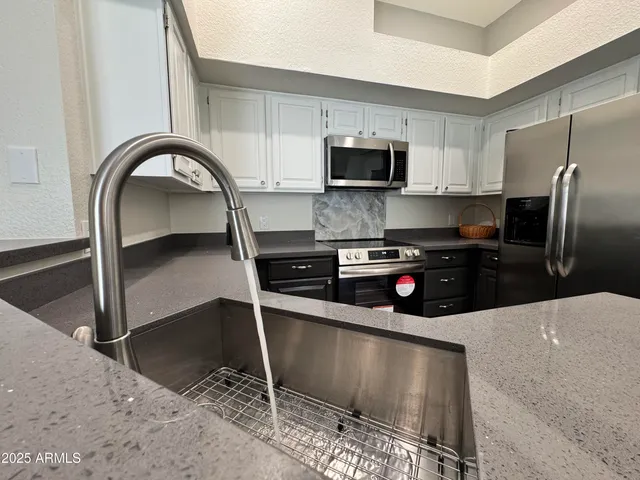 a livingroom with workspace and a window