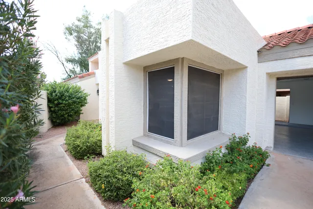 front view of a house with potted plants