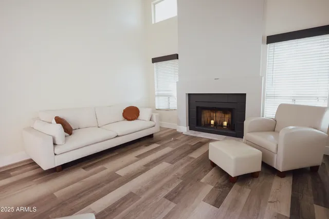 a living room with furniture and a fireplace