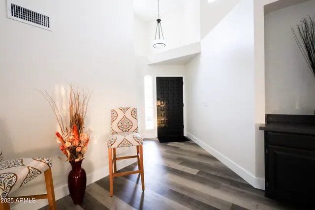 a spacious bathroom with a double vanity sink a mirror and a bathtub