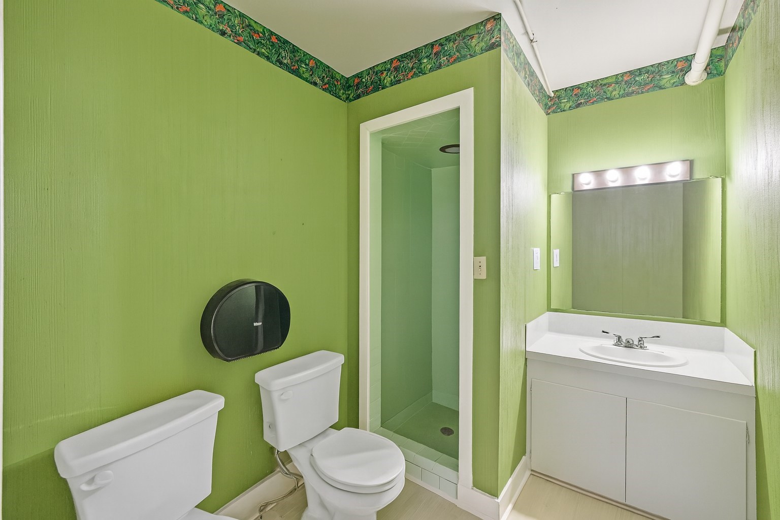 1030 4th Street Rosenberg, TX 77471 - Photo 19 of 38 a bathroom with a toilet a sink and a mirror