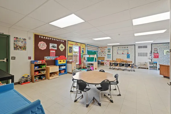 a view of a play room with furniture