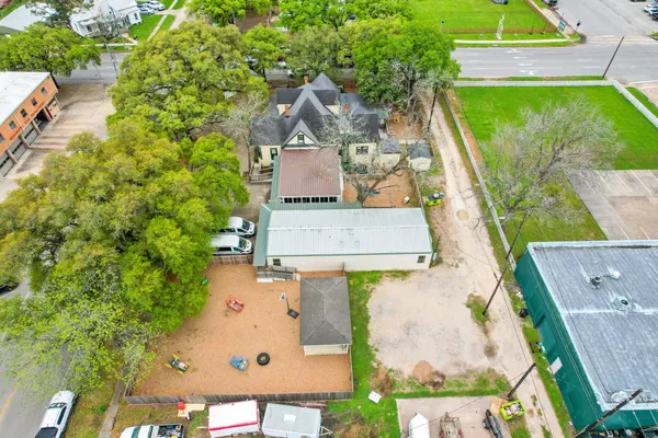 an aerial view of a house with a yard and lake view