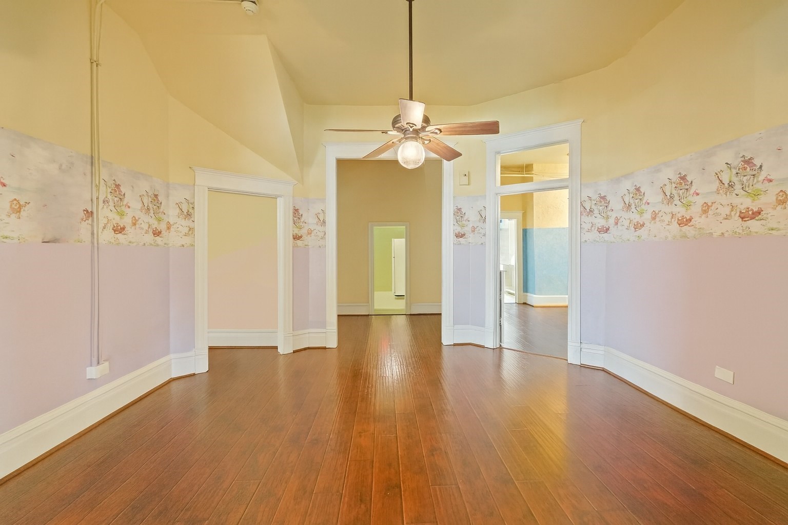 1030 4th Street Rosenberg, TX 77471 - Photo 6 of 38 a view of a livingroom with wooden floor and a ceiling fan