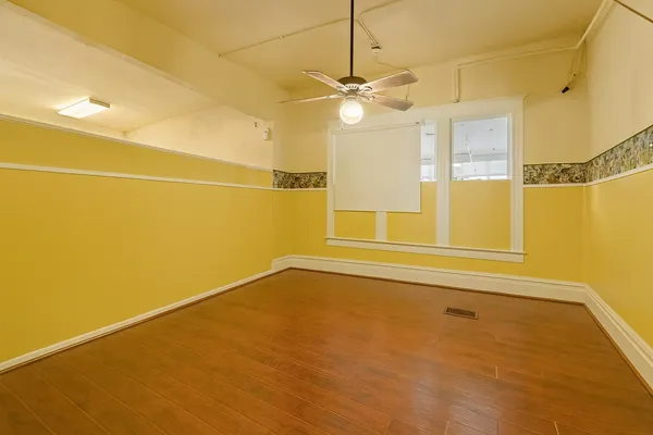 a view of a room with window and a ceiling fan