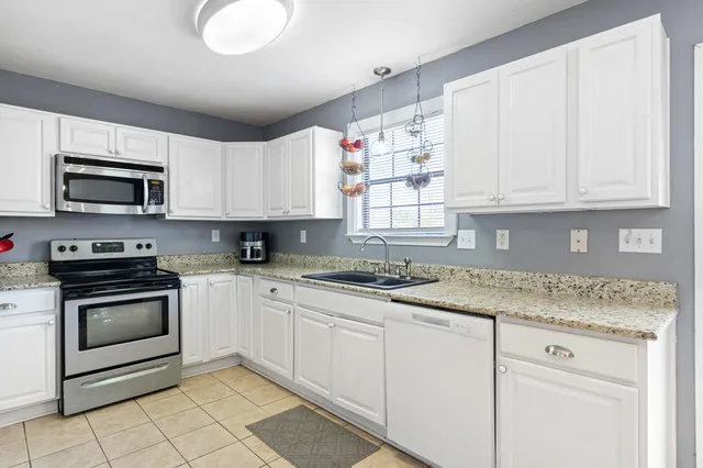 a bedroom with a bed a table and window
