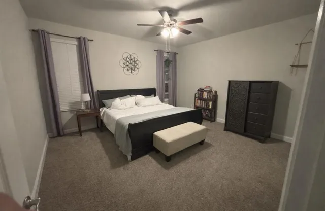 a view of a dining room with a table and chairs
