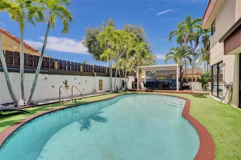 a swimming pool with outdoor seating and yard