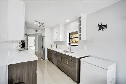 an empty room with ceiling fan and windows
