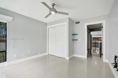 a spacious bedroom with a bed and a painting on the wall