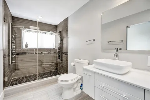 a spacious bedroom with a bed and a lamp