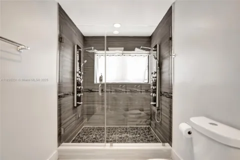 a large white bed in a room next to a window