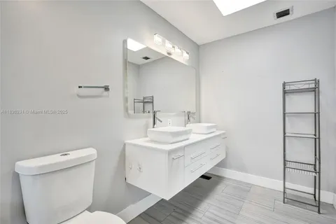 a bedroom with a bed and a flat tv screen