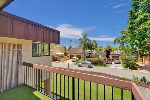 a bedroom with a bed and a large window with wooden floor