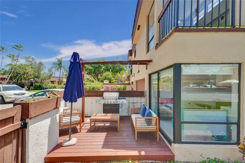 a front view of a house with a yard and green space