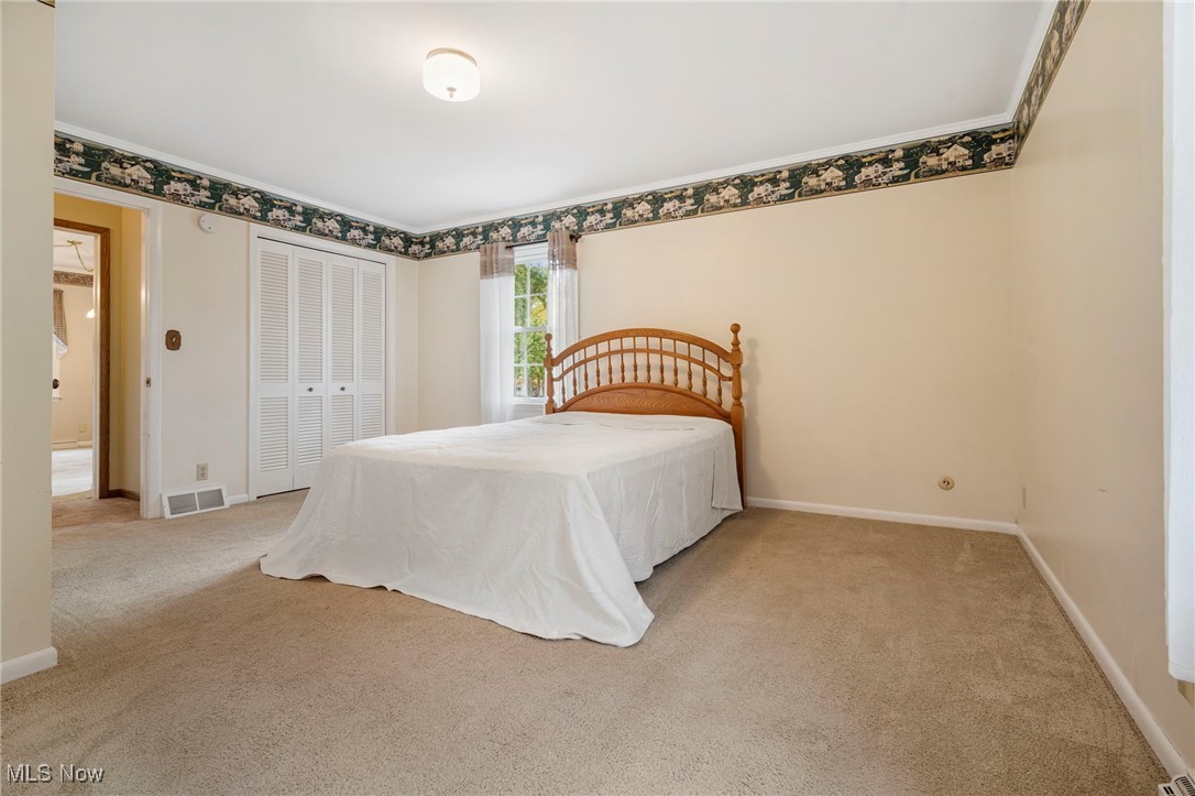 14265 Reeder Avenue Northeast Alliance, OH 44601 - Photo 17 of 39 Carpeted bedroom featuring a closet and ornamental molding