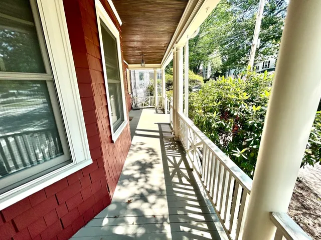 a view of balcony with wooden floor and fence