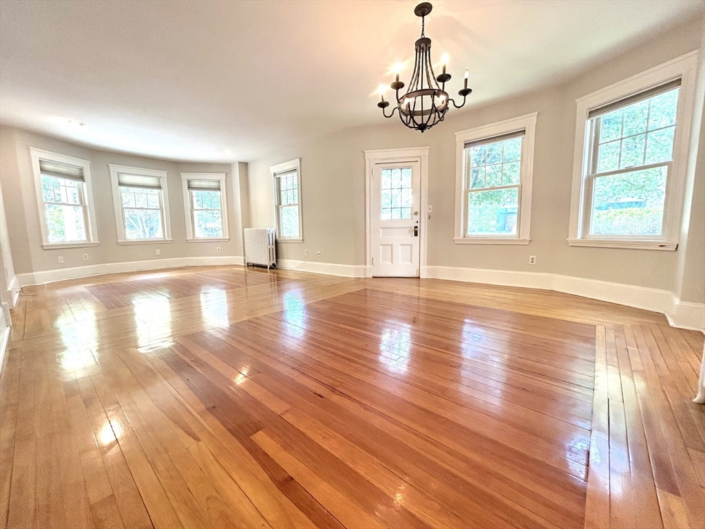 59 Ackers Avenue, Unit 1 Brookline, MA 02445 - Photo 3 of 13 a view of empty room with wooden floor and fan