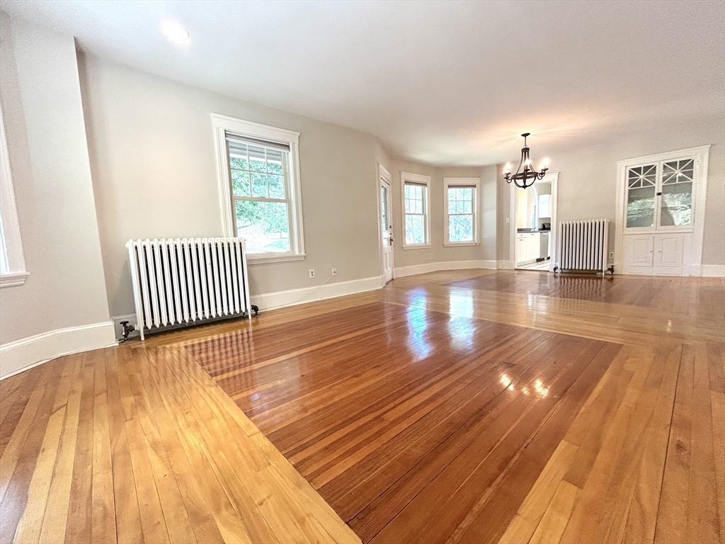 59 Ackers Avenue, Unit 1 Brookline, MA 02445 - Photo 5 of 13 a view of empty room with wooden floor and fan