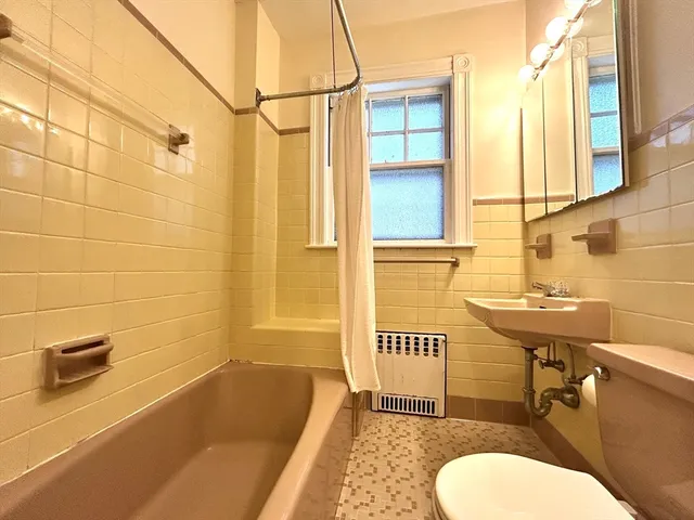 a bathroom with a sink a toilet and tub