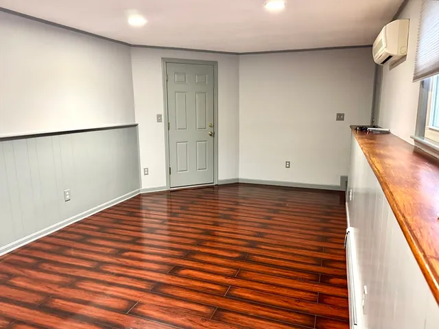 a view of a room with wooden floor