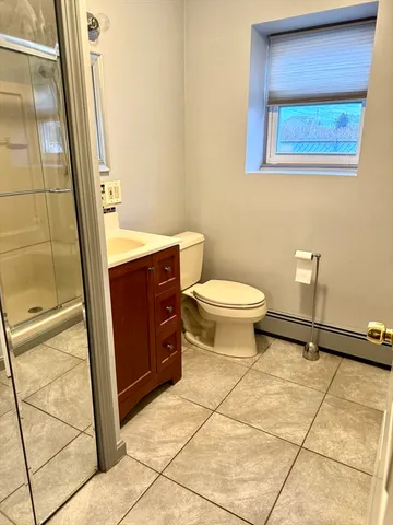 a bathroom with a toilet and a shower