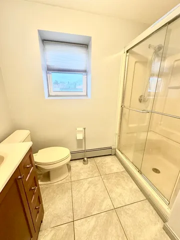 a bathroom with a toilet and a shower