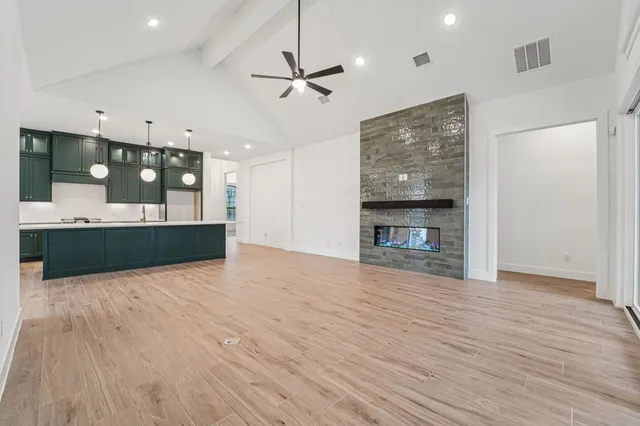 a view of a kitchen with a dishwasher and a fireplace