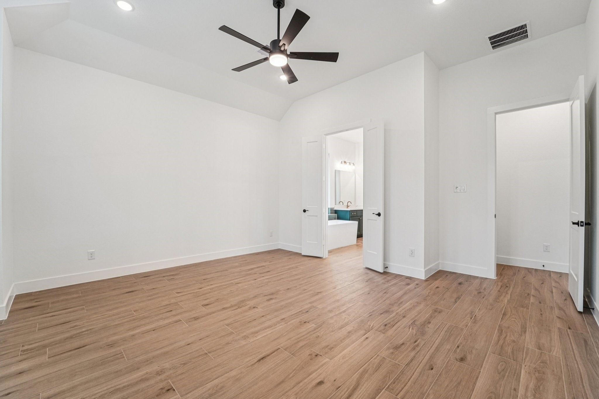 15727 Hoptree Hts Lane Conroe, TX 77302 - Photo 21 of 44 an empty room with wooden floor and a ceiling fan