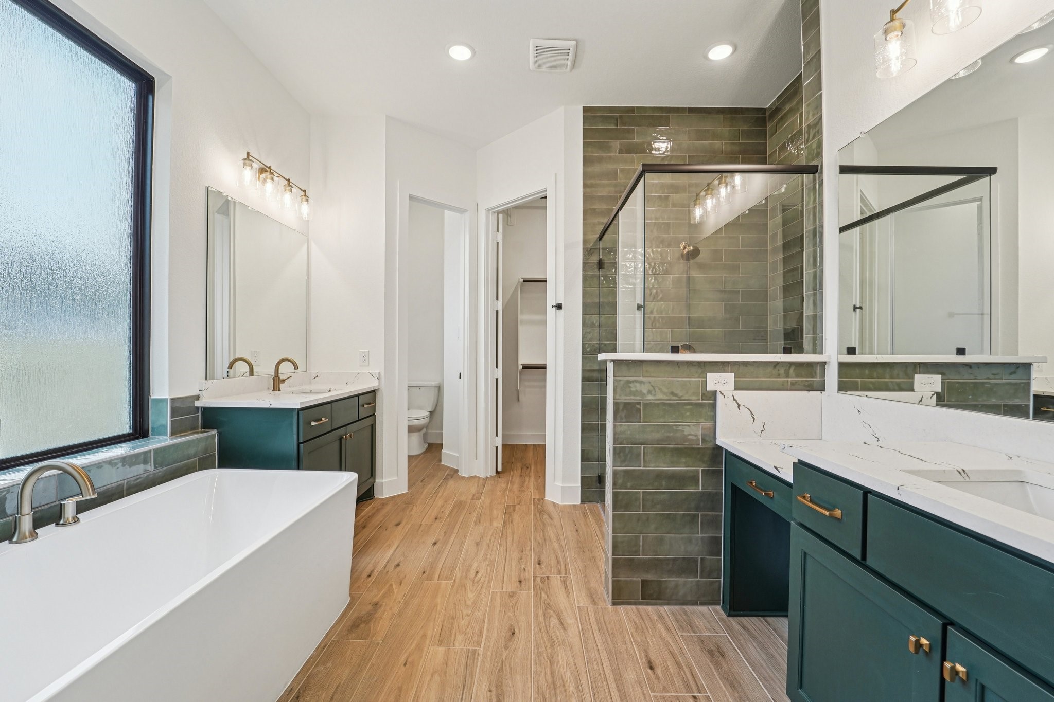 15727 Hoptree Hts Lane Conroe, TX 77302 - Photo 24 of 44 a bathroom with a double vanity sink a mirror and a shower