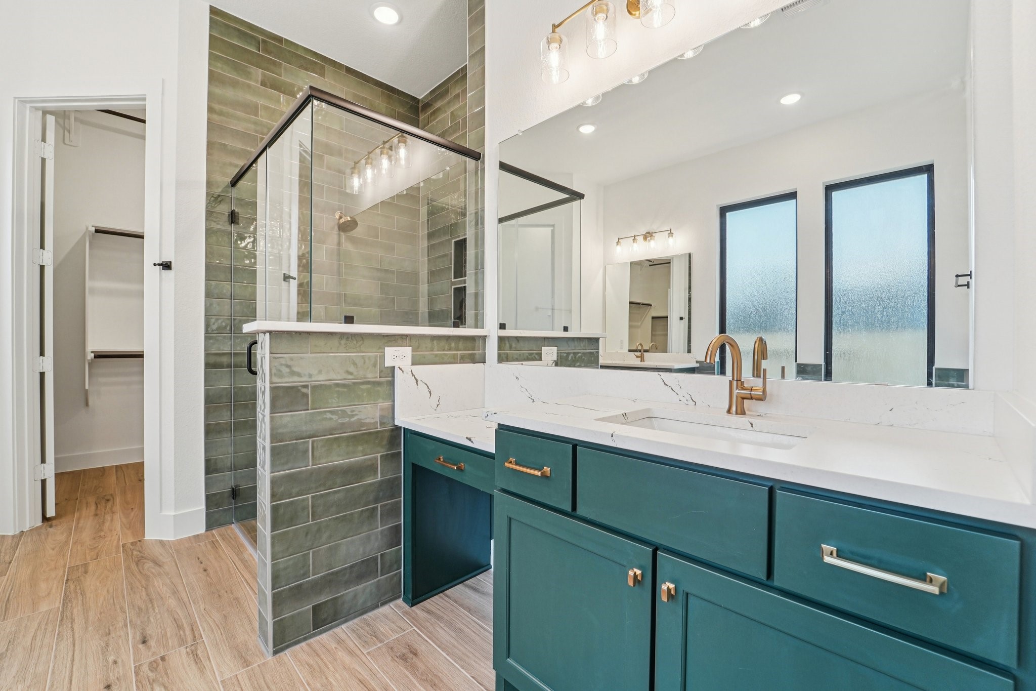 15727 Hoptree Hts Lane Conroe, TX 77302 - Photo 26 of 44 a bathroom with a sink mirror and a shower