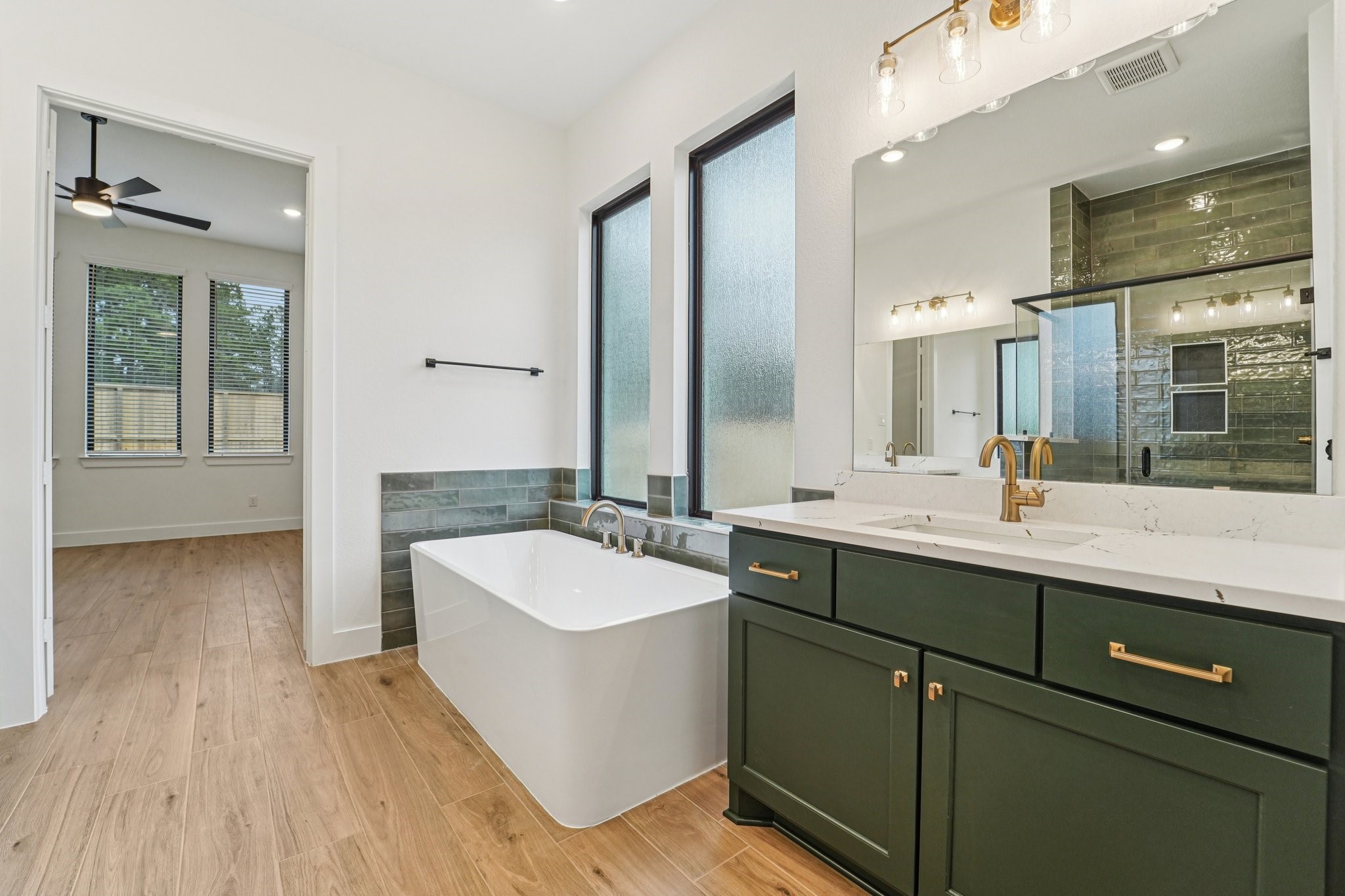 15727 Hoptree Hts Lane Conroe, TX 77302 - Photo 27 of 44 a spacious bathroom with a double vanity sink a mirror and a bathtub