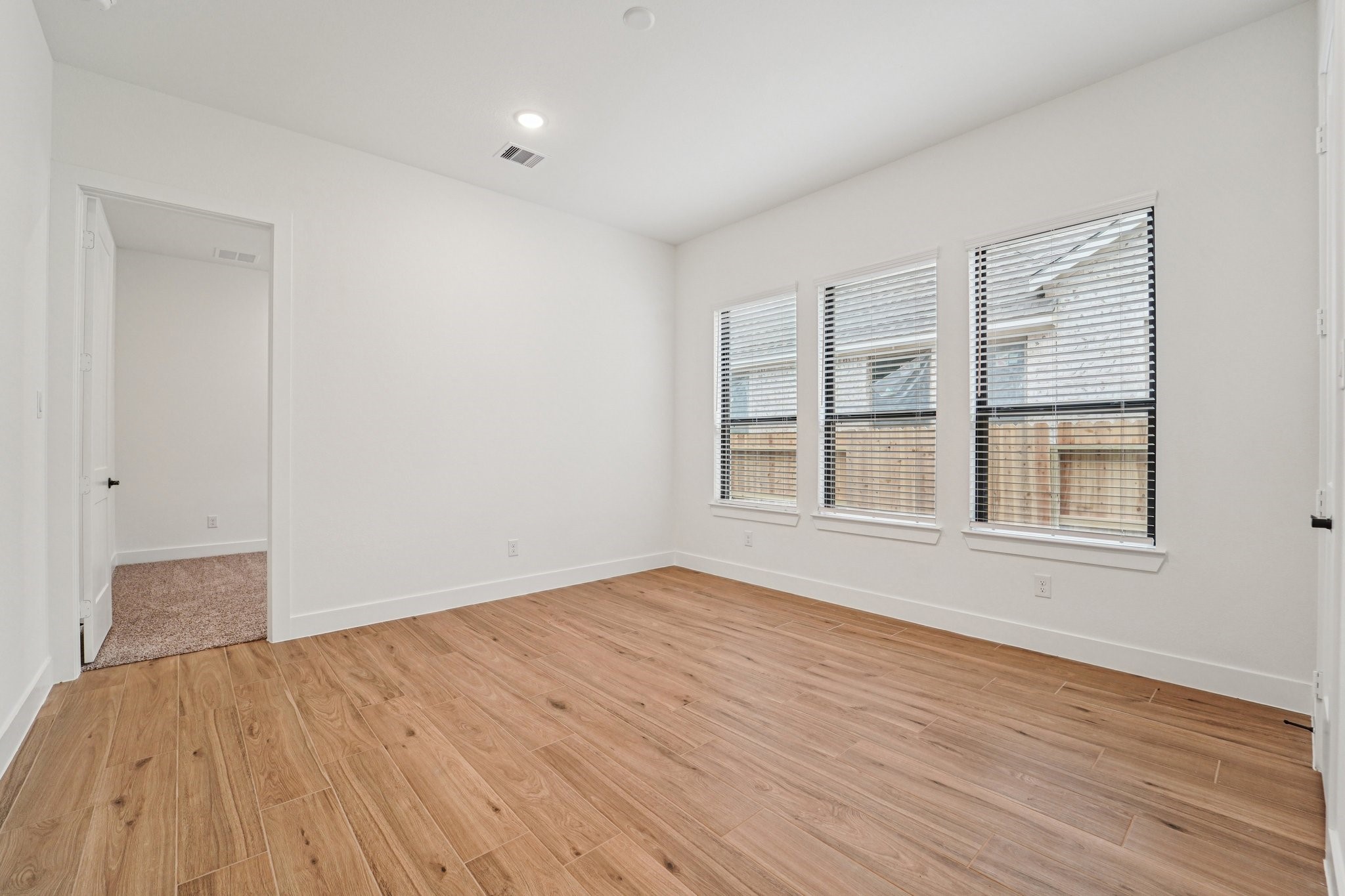 15727 Hoptree Hts Lane Conroe, TX 77302 - Photo 29 of 44 a view of an empty room with wooden floor and a window