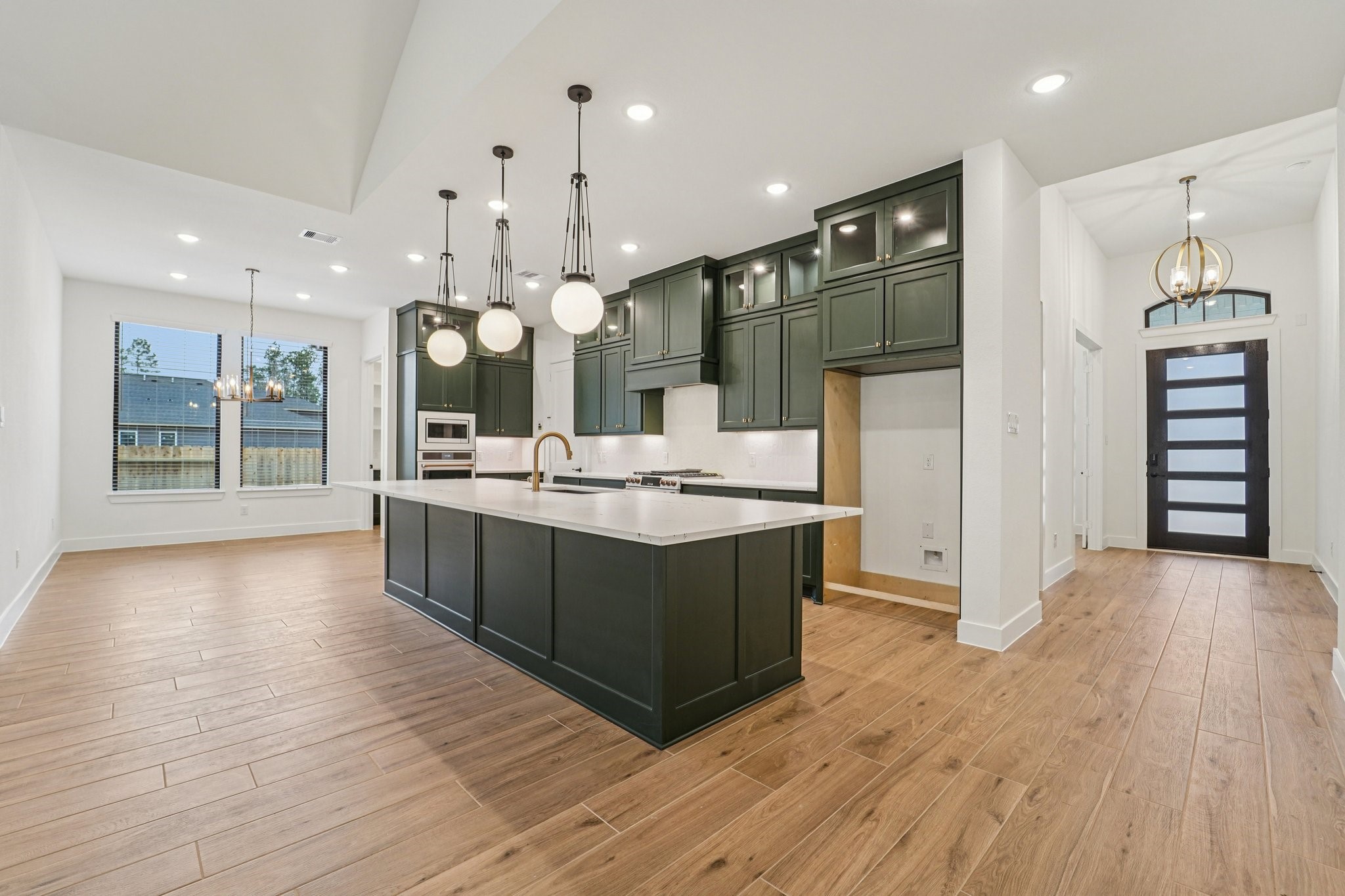 15727 Hoptree Hts Lane Conroe, TX 77302 - Photo 4 of 44 a large kitchen with stainless steel appliances kitchen island granite countertop a large counter top and sink
