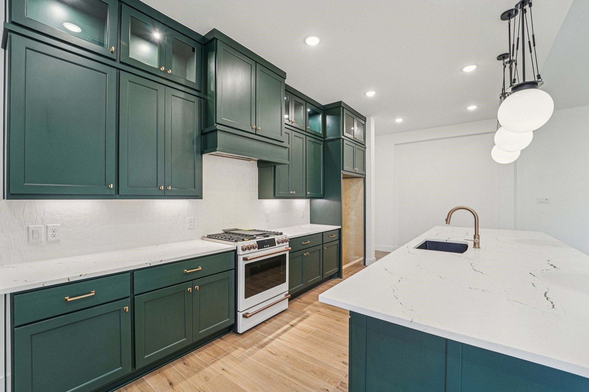 15727 Hoptree Hts Lane Conroe, TX 77302 - Photo 5 of 44 a kitchen with a sink and cabinets