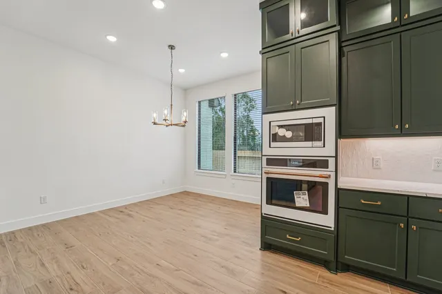 a kitchen with granite countertop a refrigerator and a stove
