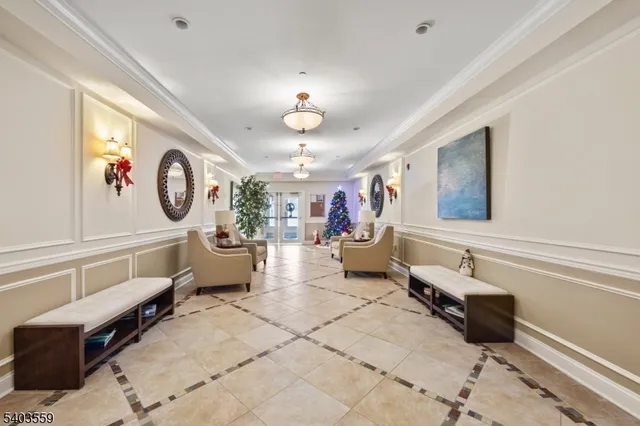 a living room with furniture and a chandelier