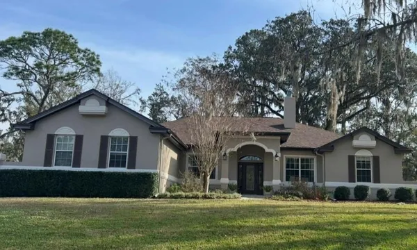 a front view of a house with a garden