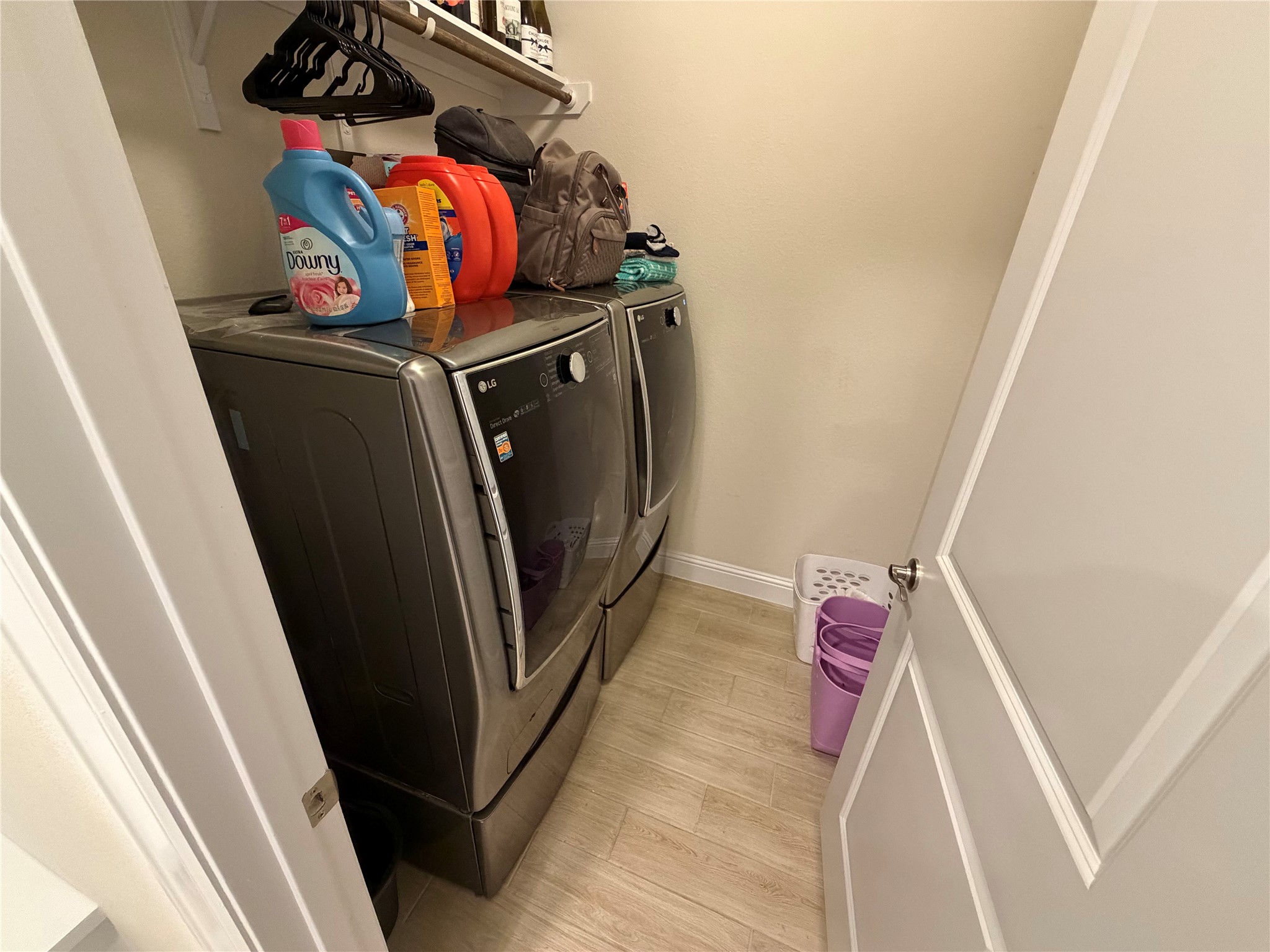 8709 Moccasin Path Austin, TX 78736 - Photo 10 of 34 Laundry area with washing machine and dryer and light wood-style floors