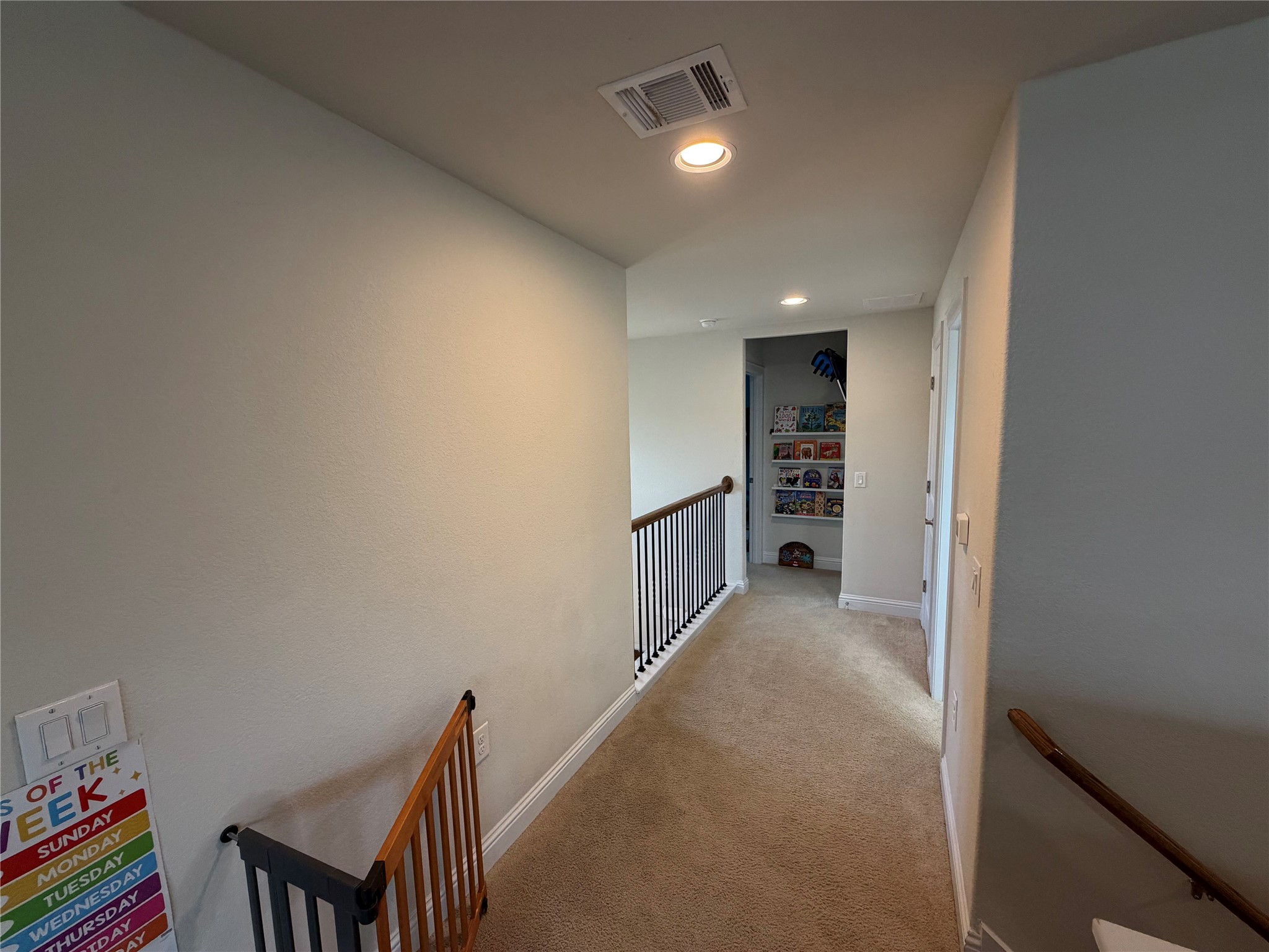 8709 Moccasin Path Austin, TX 78736 - Photo 13 of 34 Hallway with an upstairs landing, recessed lighting, and light colored carpet