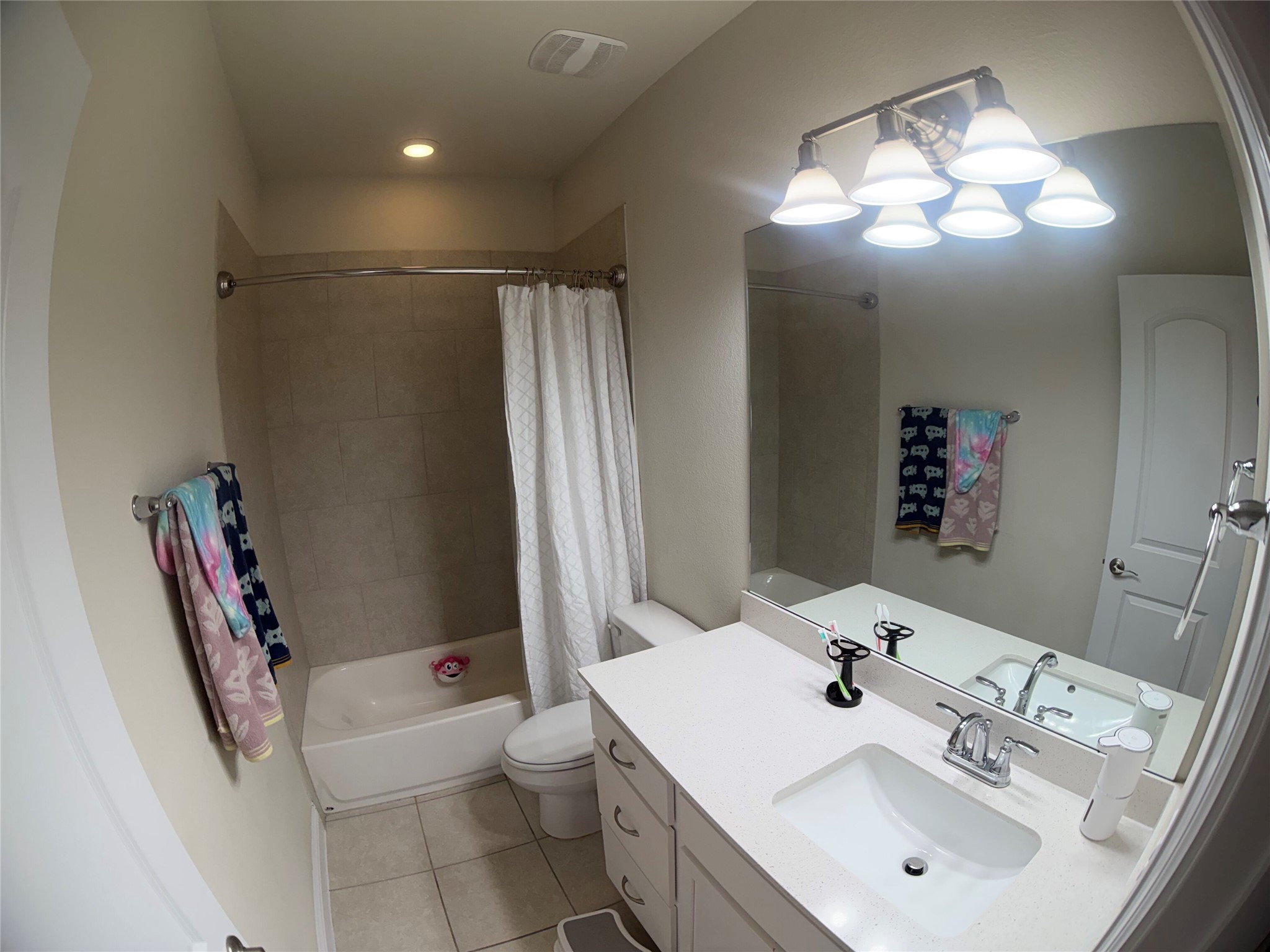8709 Moccasin Path Austin, TX 78736 - Photo 14 of 34 Bathroom featuring vanity, shower / bath combination with curtain, and light tile patterned flooring