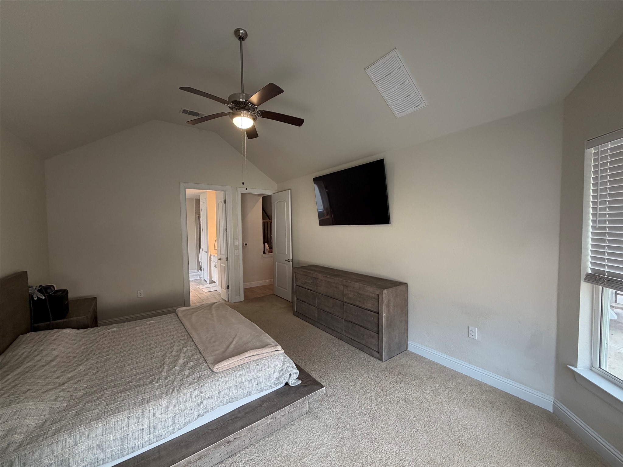8709 Moccasin Path Austin, TX 78736 - Photo 17 of 34 Carpeted bedroom featuring a ceiling fan and ensuite bathroom