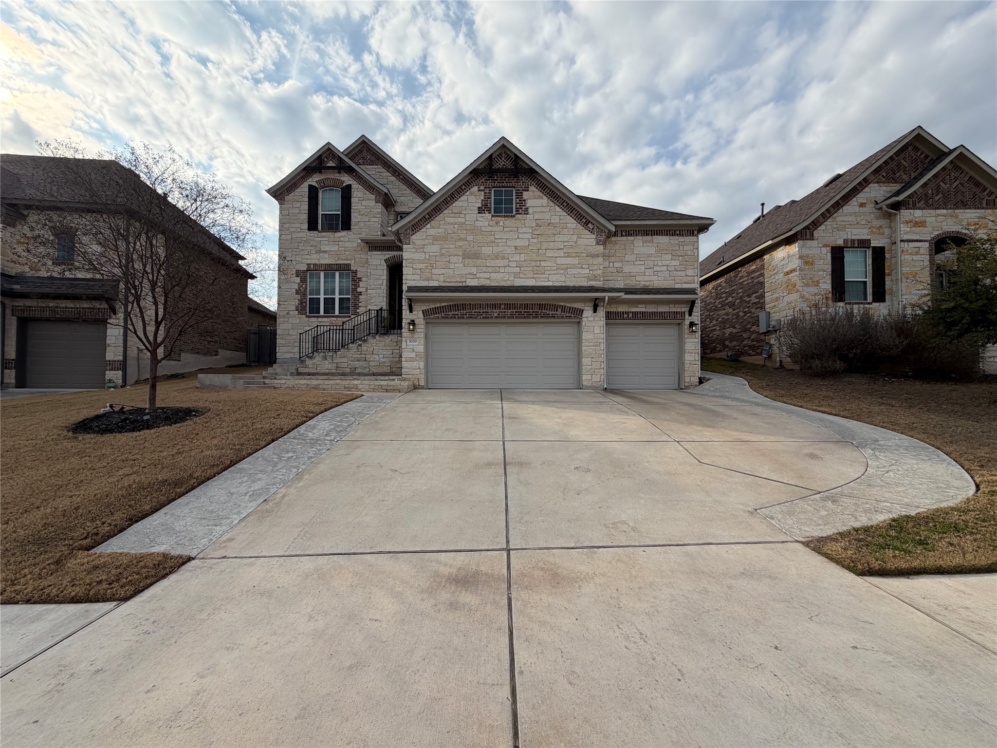 8709 Moccasin Path Austin, TX 78736 - Photo 28 of 34 French country home with stone siding, driveway, and a garage