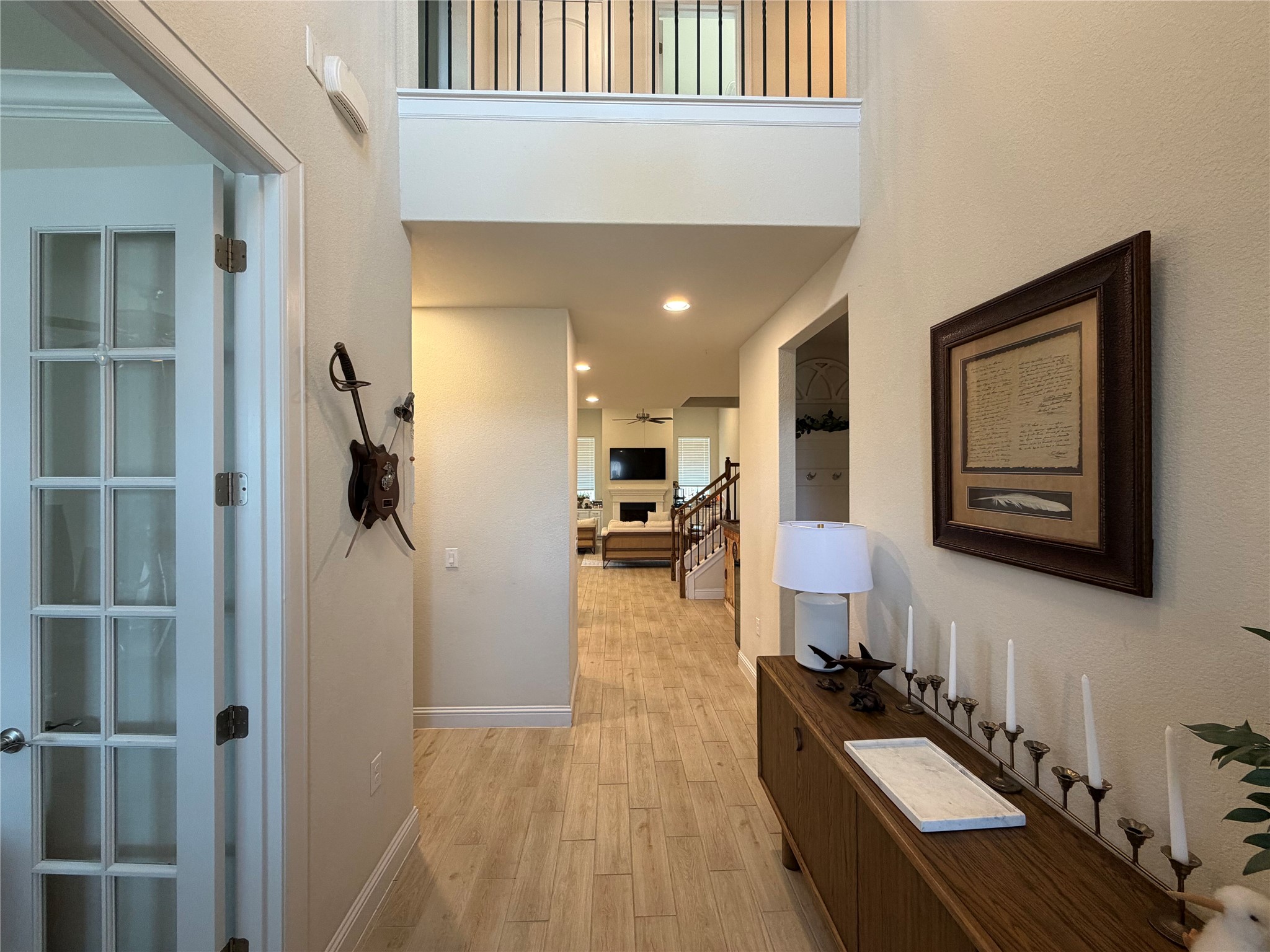 8709 Moccasin Path Austin, TX 78736 - Photo 4 of 34 Hallway featuring light wood-style floors, recessed lighting, and a high ceiling