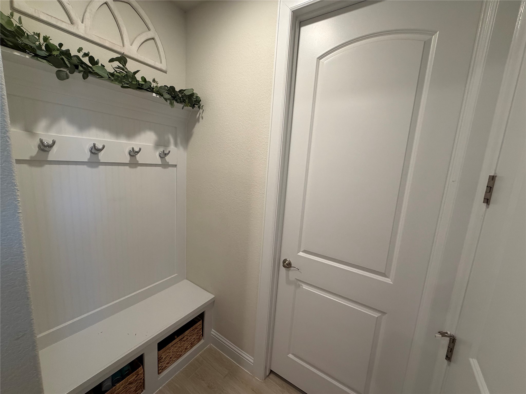 8709 Moccasin Path Austin, TX 78736 - Photo 9 of 34 Mudroom featuring light wood-style flooring and a textured wall