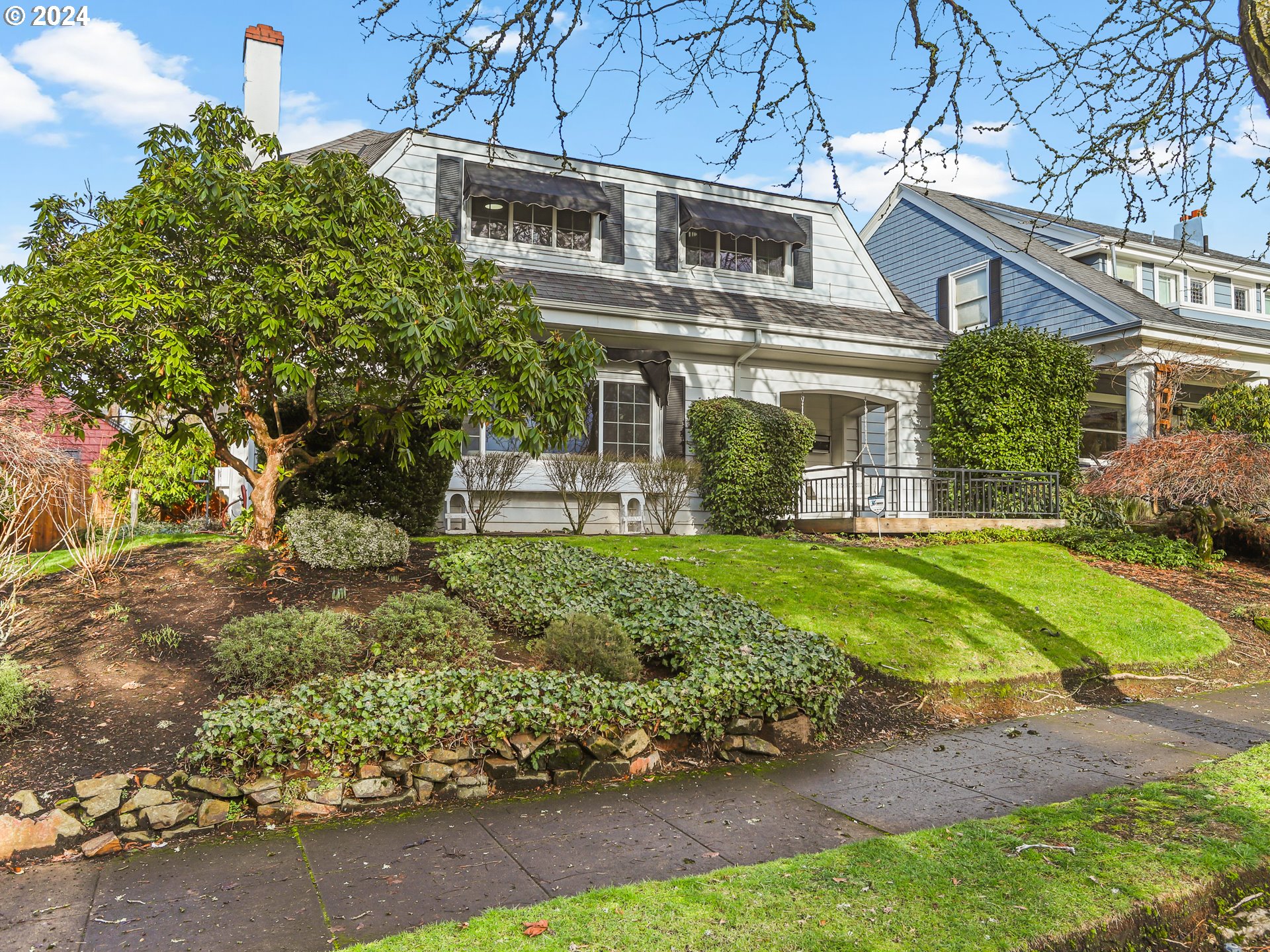 a front view of a house with garden